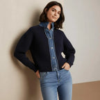 Woman in navy knit cardigan with denim collar, button front, and ribbed cuffs.