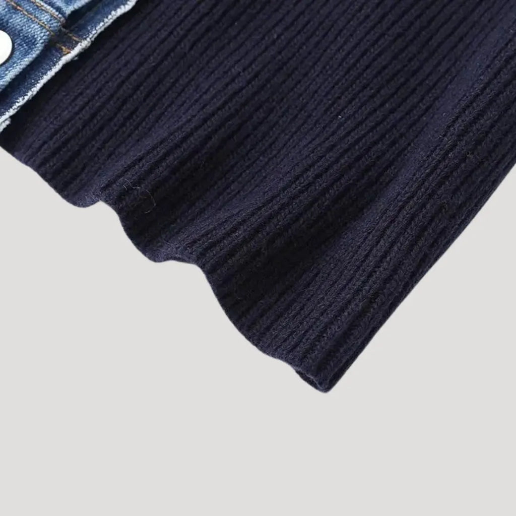 Navy blue ribbed knit cardigan with a denim collar and white button detail.