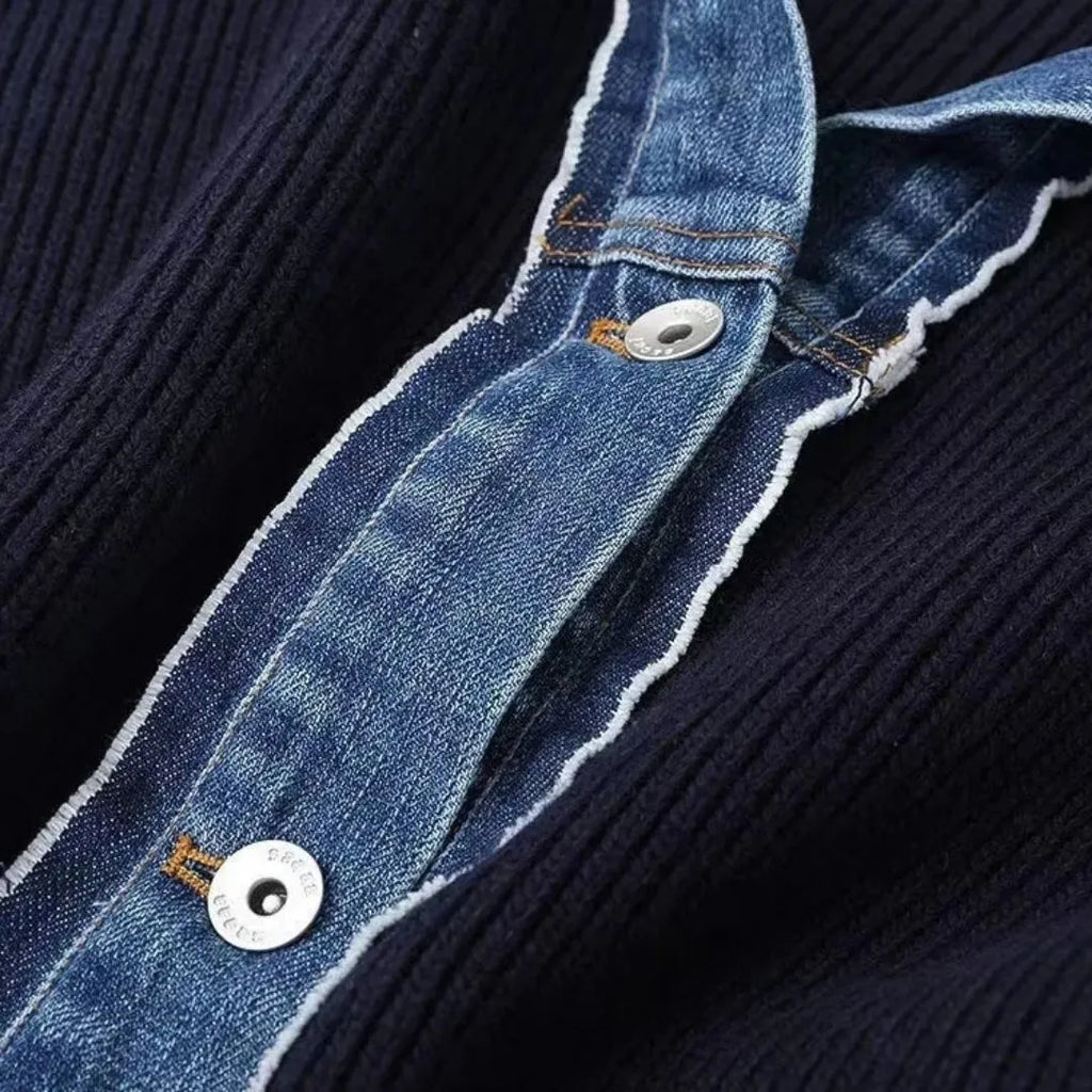 Close-up of a navy blue ribbed knit cardigan with a denim collar and silver buttons.