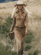 Blonde woman in a light brown suede-look Western-Bohemian dress with long fringe, zipper neckline, and cowboy hat.