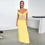 Gele satijnen maxi-jurk met open schouders en een kanten detail in de taille voor een elegante look.