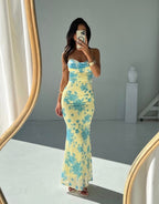 Mouwloze midi-jurk van polyester in geel met blauwe bloemenprint en ronde hals.
