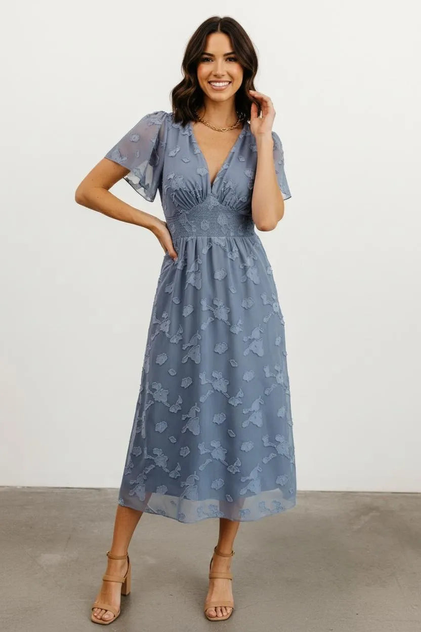 Women's dress blue floral overlay front pose hands on hips