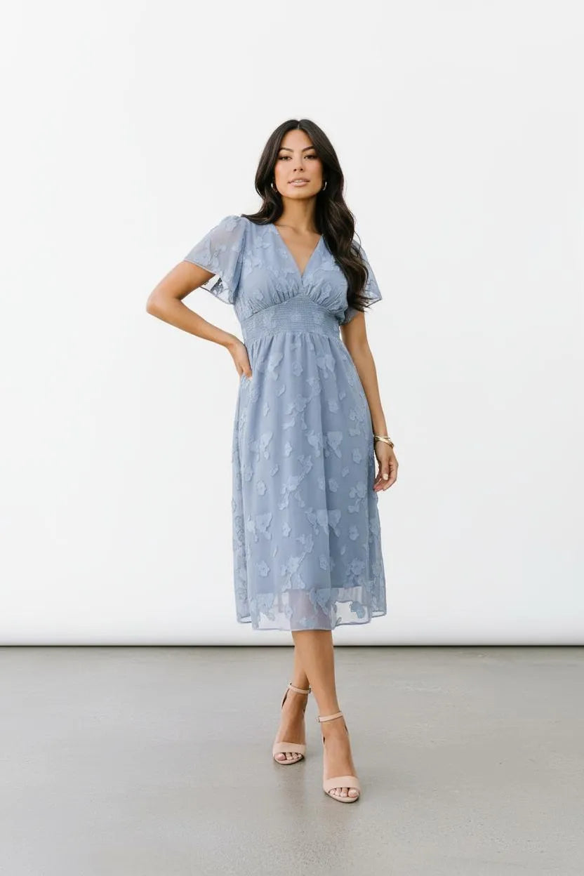 Women's dress blue floral overlay front pose hand on hip