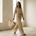 A different brunette woman, mid-length wavy hair, natural makeup, 

slim build, holding a woven straw tote bag, minimalist studio 

background warm off-white, soft diffused lighting, high-end fashion 

editorial style, photorealistic, high resolution, different person 

than reference, random natural pose, unexpected angle, 

use other pose for every photo